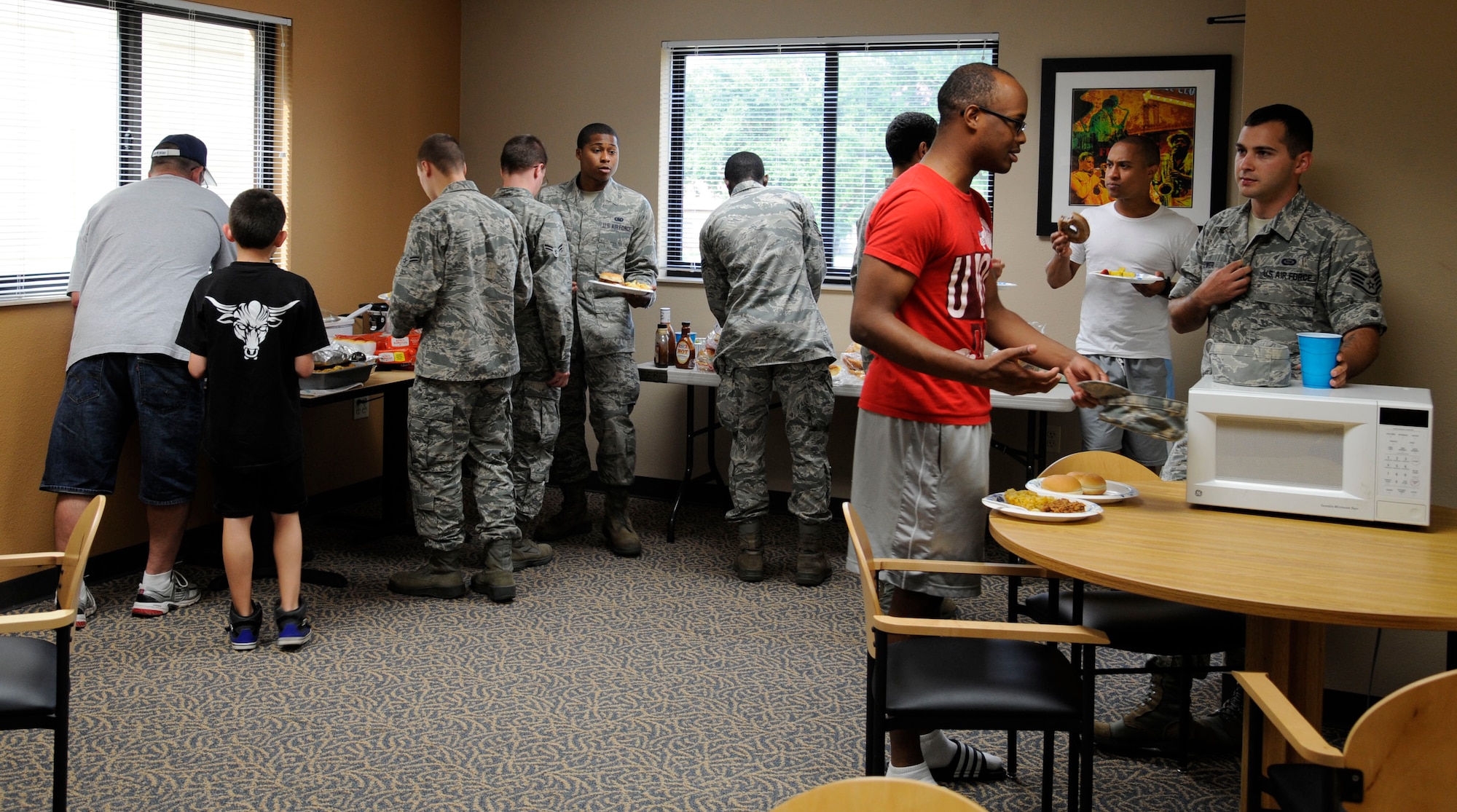Airmen go through the serving line at the Almost Mama?s Home Cooking potluck on Barksdale Air Force Base, La., June 20, 2013. Barksdale?s Top III organized the potluck to show appreciation for Airmen in the dormitories. (U.S Air Force photo/Airman 1st Class Andrew Moua)