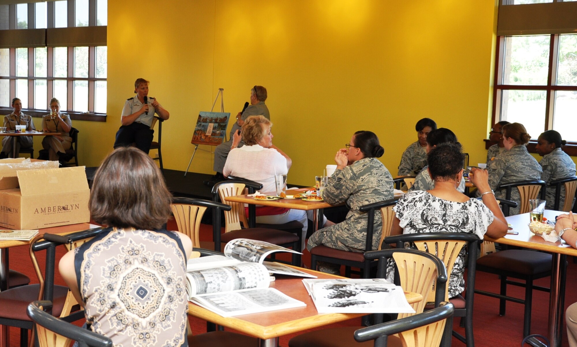 Women attending the Women’s Empowerment Group gathering listen as Col. DeAnna Burt, 460th Operations Group commander, back left, asks questions provided by the audience to Marge Alexander, member of the Marine Corps Women’s Reserve during World War II, back right, June 26, 2013, at the Panther Den on Buckley Air Force Base, Colo. Alexander joined the Marine Corps the first year women were allowed in the branch of service to support the war effort. Women provided needed support at home stations to free up men to fight overseas. Alexander answered questions about her military service and her life following her time in the Marine Corps. (U.S. Air Force photo by Staff Sgt. Kali L. Gradishar/Released)