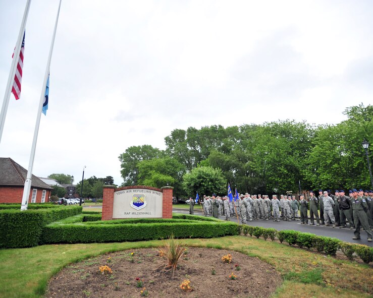 Team Mildenhall Airmen from the 100th Operations Group and 100th Wing Staff Agency stand in formation prior to the start of the monthly retreat ceremony June 28, 2013, on RAF Mildenhall, England. Retreat is a long-standing tradition honoring the flag and signaling the end of the duty day. (U.S. Air Force photo by Master Sgt. Brian M. Boisvert/Released) 