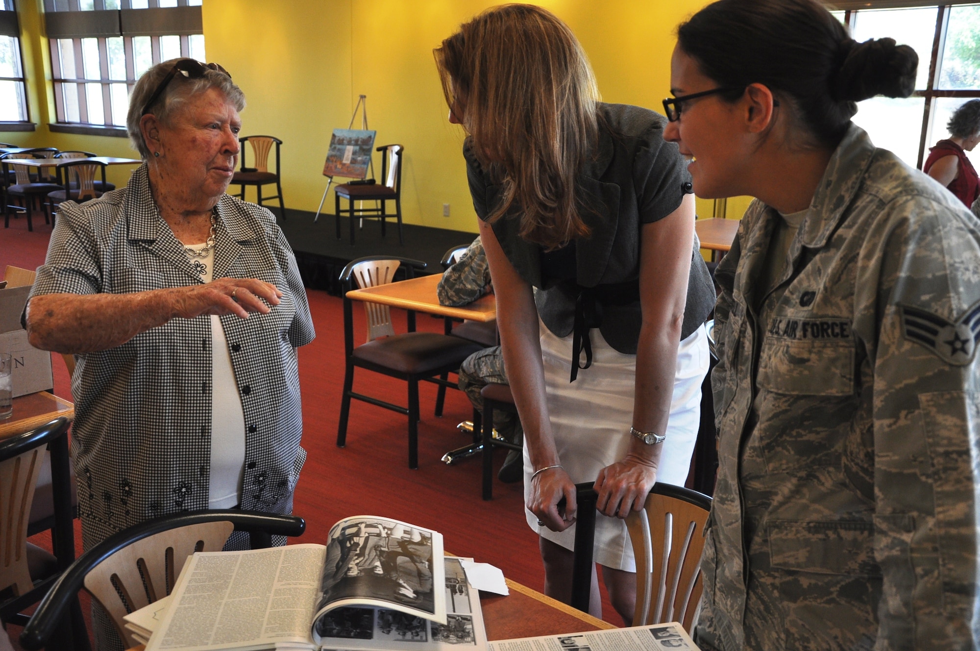 Marge Alexander, member of the Marine Corps Women’s Reserve during World War II, left, talks with Christina Stump, 460th Space Wing community support coordinator, center, and Senior Airman Reagan Dowell, 460th Comptroller Squadron, June 26, 2013, at the Panther Den on Buckley Air Force Base, Colo. Alexander joined the Women’s Reserve in 1943, the same year women were finally allowed in the Marine Corps. She shared her life story with approximately 30 participants in the Women’s Empowerment Group on base formed to empower women and provide professional networking and camaraderie. (U.S. Air Force photo by Staff Sgt. Kali L. Gradishar/Released)