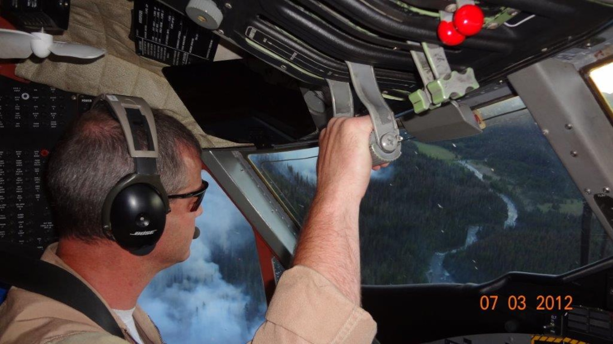 466th Fighter Squadron commander Lt. Col. Paul “Buster” Delmonte flies above the Bear Cub Fire in Wyoming’s Teton Wilderness Area last year in his civilian job as an aerial firefighter with the U.S. Forest Service. During the summer months each year, he drops smokejumpers and directs the delivery of fire retardant on wildfires across the U.S. (Courtesy photo)