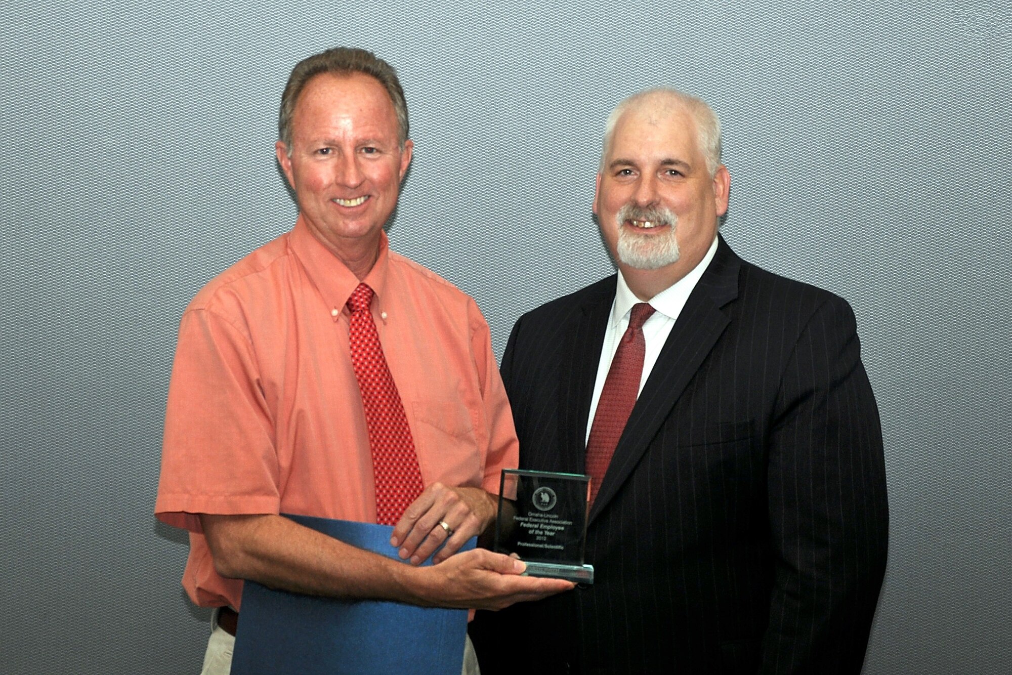 Ken Smith, Air Force Weather Agency, is presented the Omaha-Lincoln Federal Executive Association's 2012 professional and scientific employee of the year award by Keith Reid, FEA president, May 16 at the University of Nebraska at Omaha's Thompson Alumni Center. The FEA award program is open to all federal employees, including both military and civilian, in the Omaha-Lincoln area. (courtesy photo)