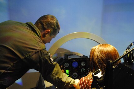 A participant in the Tuskegee Airmen Incorporated Youth Seminar practices flying in a T-6 Texan II flight simulator, June 21, 2013 at Joint Base San Antonio-Randolph, Texas. During their time on base, the youth learned about the legacy of the Tuskegee Airmen and aviation.  (U.S. Air Force photo by Bekah Clark)