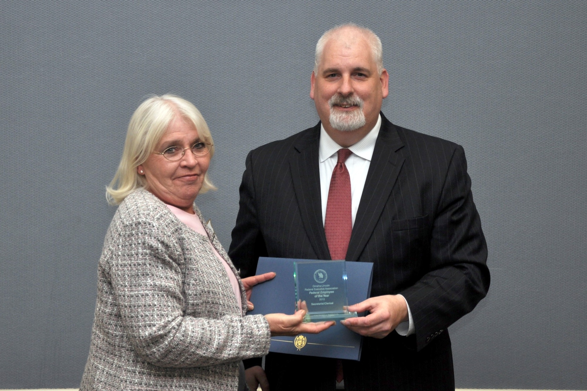 Victoria Downs, 55th Operations Group, is presented the Omaha-Lincoln Federal Executive Association's 2012 secretarial and clerical employee of the year award by Keith Reid, FEA president, May 16 at the University of Nebraska at Omaha's Thompson Alumni Center. The FEA award program is open to all federal employees, including both military and civilian, in the Omaha-Lincoln area. (courtesy photo)