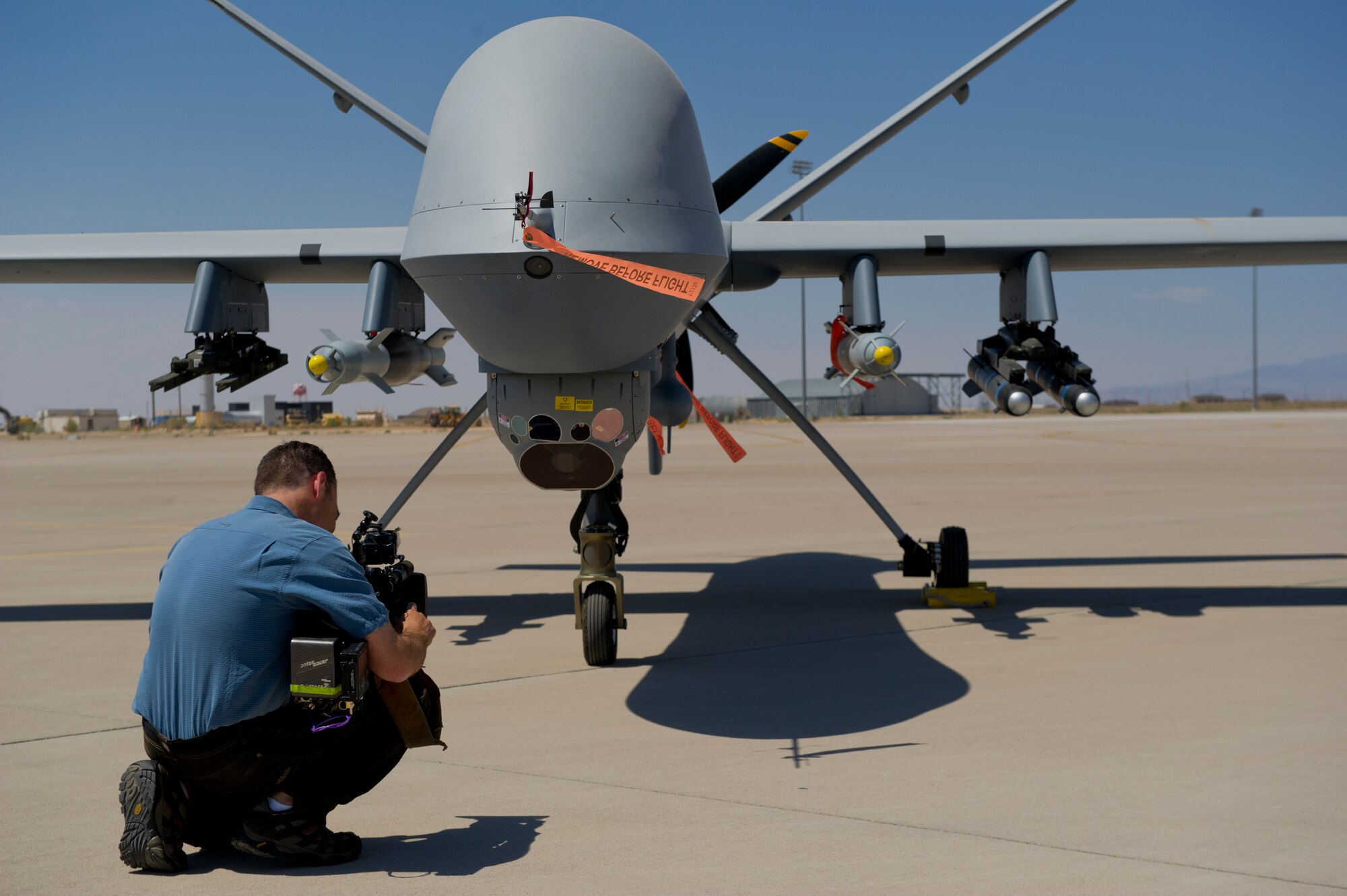Aaron Sasson, NBC Today Show cameraman, records footage of an MQ-9 Reaper static display at Holloman Air Force Base, N.M., June 24. A static display of the Remotely Piloted Aircraft was set up for the media outlets that visited Holloman AFB. The Today Show visited Holloman AFB to learn about and document the MQ-1 Predator and MQ-9 Reaper training program. (U.S. Air Force photo by Airman 1st Class Aaron Montoya/Released)