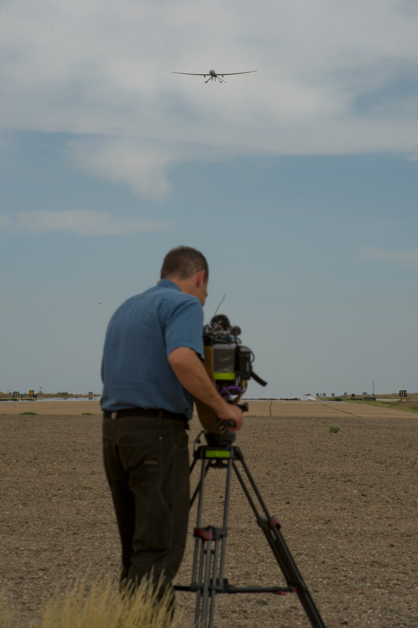 Aaron Sasson, NBC Today Show cameraman, records footage of the MQ-1 Predator preparing to land at Holloman Air Force Base, N.M., June 24. The Today Show visited Holloman AFB to do a report on the Remotely Piloted Aircraft training program. (U.S. Air Force photo by Airman 1st Class Aaron Montoya/Released)