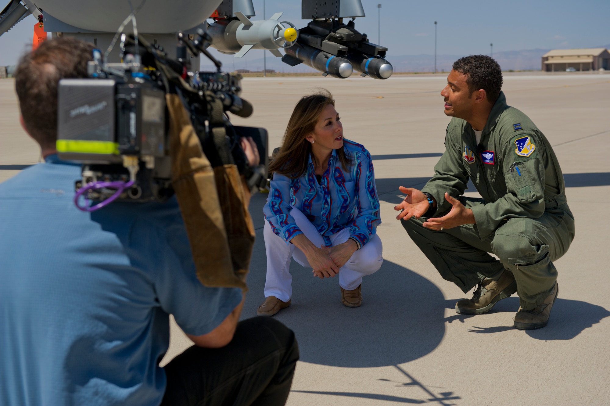 Janet Shamlian, NBC Today Show correspondent, interviews Capt. Anthony, 9th Attack Squadron instructor pilot, about the MQ-9 Reaper at Holloman Air Force Base, N.M., June 24. Capt. Anthony explained the payload and speed differences between the MQ-1 Predator and the MQ-9 Reaper. The Today Show visited Holloman AFB to do a report on the Remotely Piloted Aircraft training program. According to current Air Force guidance, the last name of RPA pilots and sensor operators are not releasable due to operational security constraints. (U.S. Air Force photo by Airman 1st Class Aaron Montoya/Released)