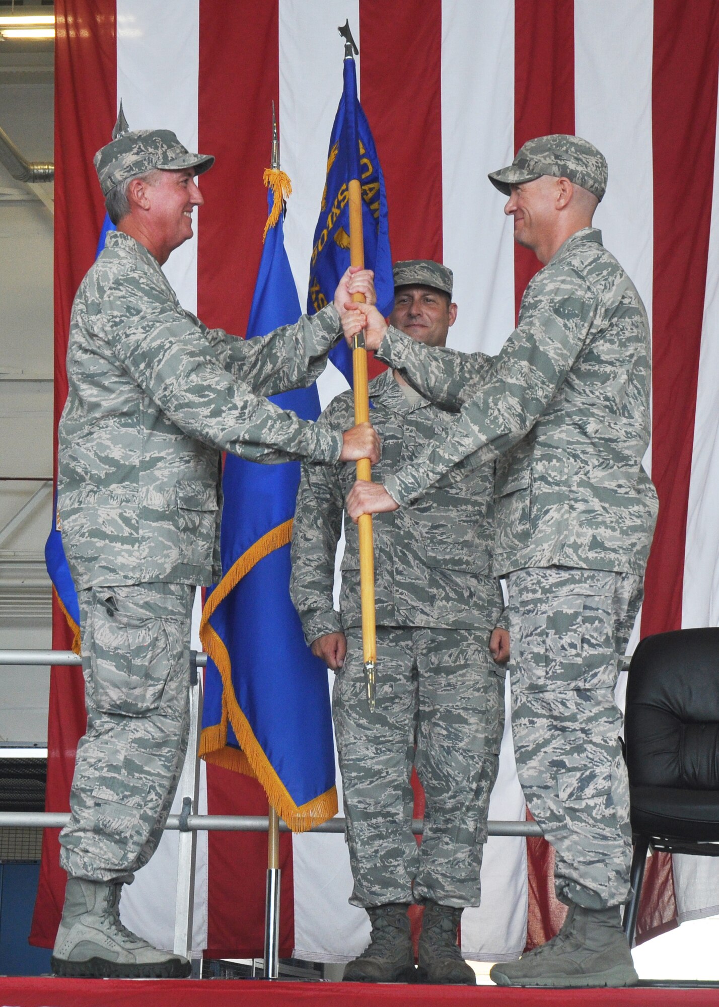 Maj. Kevin Kulz, right, receives his unit guidon from Brig. Gen. Jon Weeks, Air Force Special Operations Air Warfare Center commander, during a ceremony that installed him as commander of the newly activated 592nd Special Operations Maintenance Squadron June 27, 2013 at Duke Field, Fla.  Kulz's active-duty unit, part of the AFSOAWC, will provide maintenance support for the Duke-based C-145A Skytruck aviation foreign internal defense aircraft alongside their reservist counterparts from the 919th Maintenance Group.  (U.S. Air Force photo/Dan Neely)