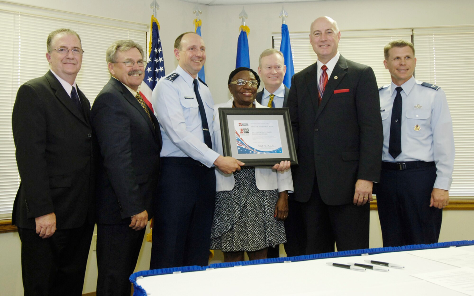 Lt. Gen. Bruce Litchfield, Air Force Sustainment Center commander, third from left, poses for a photograph with several key community leaders after presenting Tinker Air Force Base with the Association of Defense Communities 2013 Installation of the Year Award here Wednesday.  The Defense Community Award recognizes Tinker for leadership in building innovative partnerships with its host community that enhance military missions and promote installation efficiency. Pictured with General Litchfield are, from left, Del City Mayor Brian Linley, Midwest City Mayor Jack Fry, Oklahoma County Commissioner Willa Johnson, Oklahoma City Mayor Mick Cornett, Oklahoma County Commissioner Ray Vaughn, and Col. Steven Bleymaier, 72nd Air Base Wing and Tinker installation commander. The community leaders were on hand for the official signing of a Community Partnership Initiative Charter.  Tinker is the first of three Air Force Sustainment Center bases to sign an official charter. Look for details on the charter signing in next week’s Tinker Take Off. 