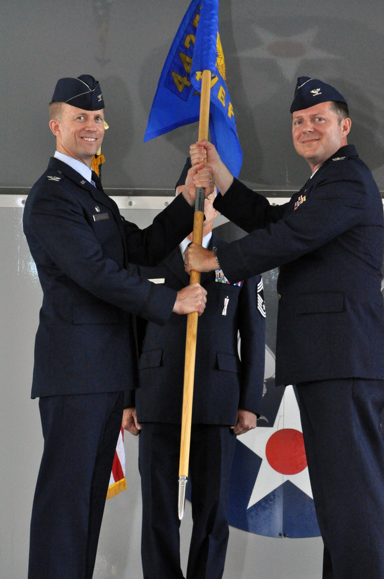 MOODY AIR FORCE BASE, Ga. -- Col. Hubert Hegtvedt, 442nd Fighter Wing commander, passes command of the 476th Fighter group to Col. James Travis during a change of command ceremony June 23, 2013. During the ceremony, Col. Christian Funk relinquished command after serving the group for two years. The 476th Fighter Group is a geographically separated unit of the 442nd Fighter Wing, Whiteman AFB, Mo. The 442nd Fighter Wing is an A-10 Thunderbolt II Air Force Reserve unit. (U.S. Air Force photo by Tech. Sgt. Danielle Johnston/Released)