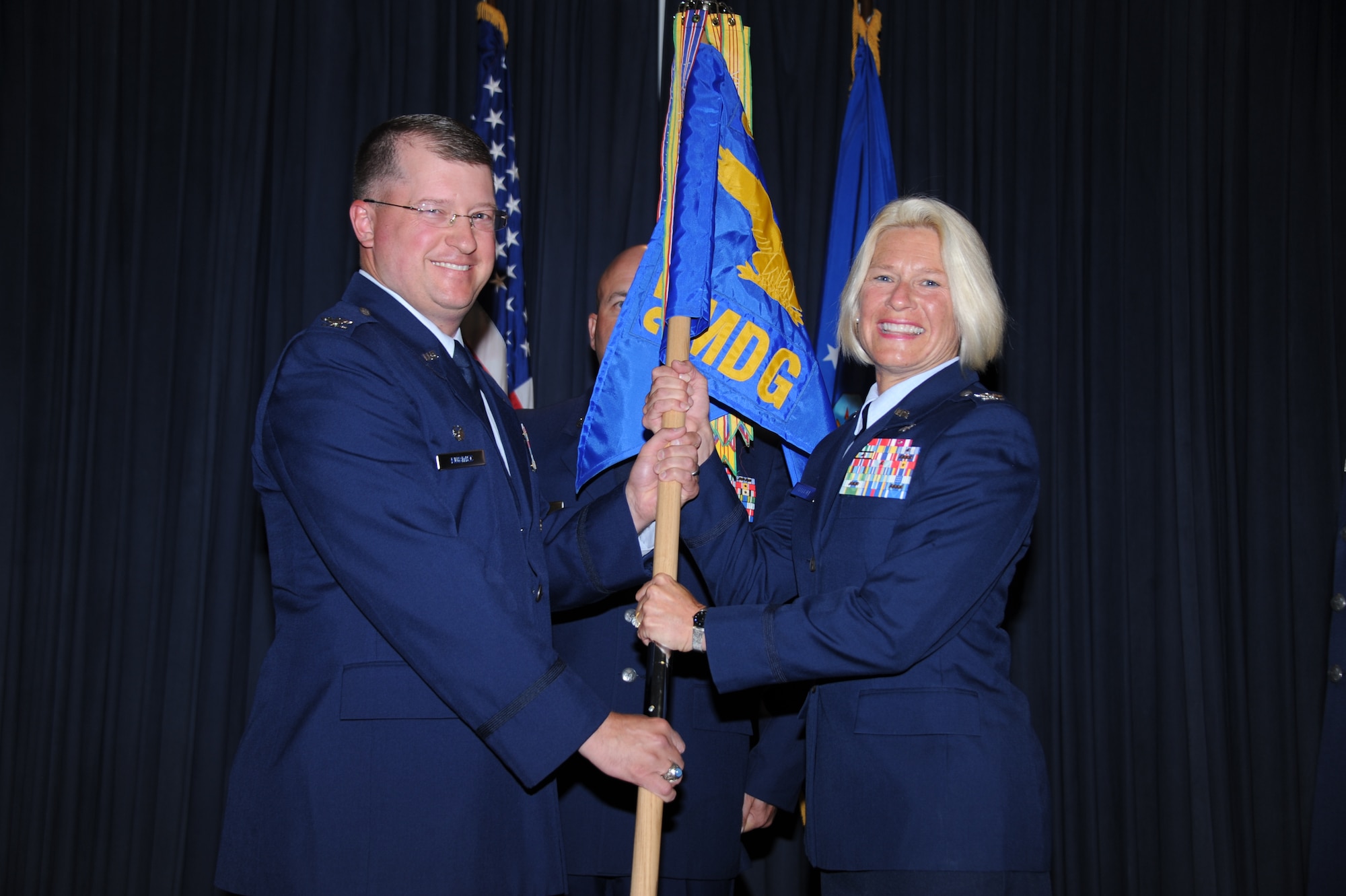Col. John Kubinec, 377th Air Base Wing commander, left, presided at a change of command ceremony June 26 in which Col. Rachel Lefebvre, right, assumed command of the 377th Medical Group. 
Photo by Todd Berenger 