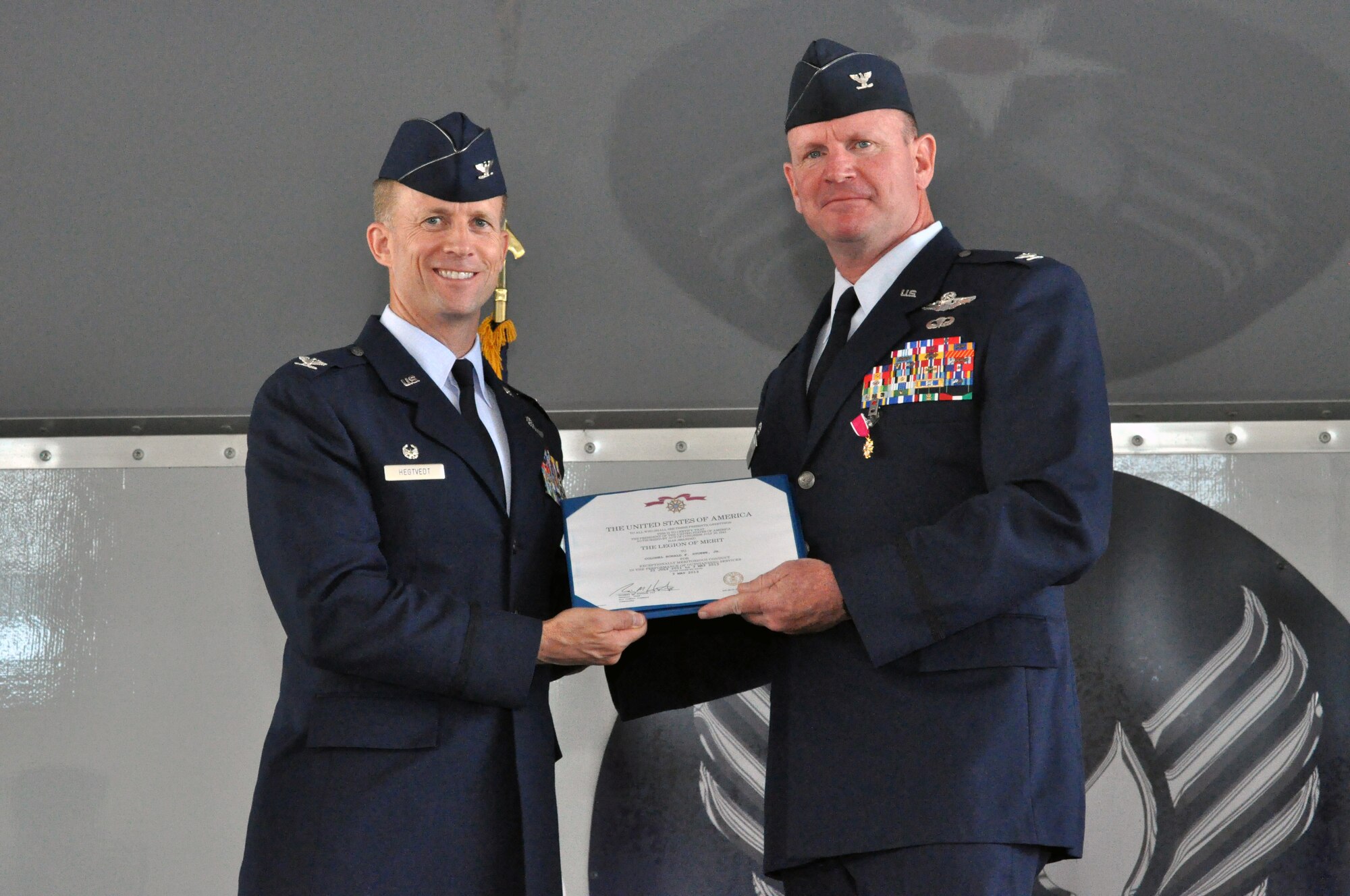 MOODY AIR FORCE BASE, Ga. -- Col. Hubert Hegtvedt, 442nd Fighter Wing commander, presents the Legion of Merit award to Col. Christian Funk during a change of command ceremony June 23, 2013. During the ceremony, Funk passed command of the group to Col. James Travis. The 476th Fighter Group is a geographically separated unit of the 442nd Fighter Wing, Whiteman AFB, Mo. The 442nd Fighter Wing is an A-10 Thunderbolt II Air Force Reserve unit. (U.S. Air Force photo by Tech. Sgt. Danielle Johnston/Released)