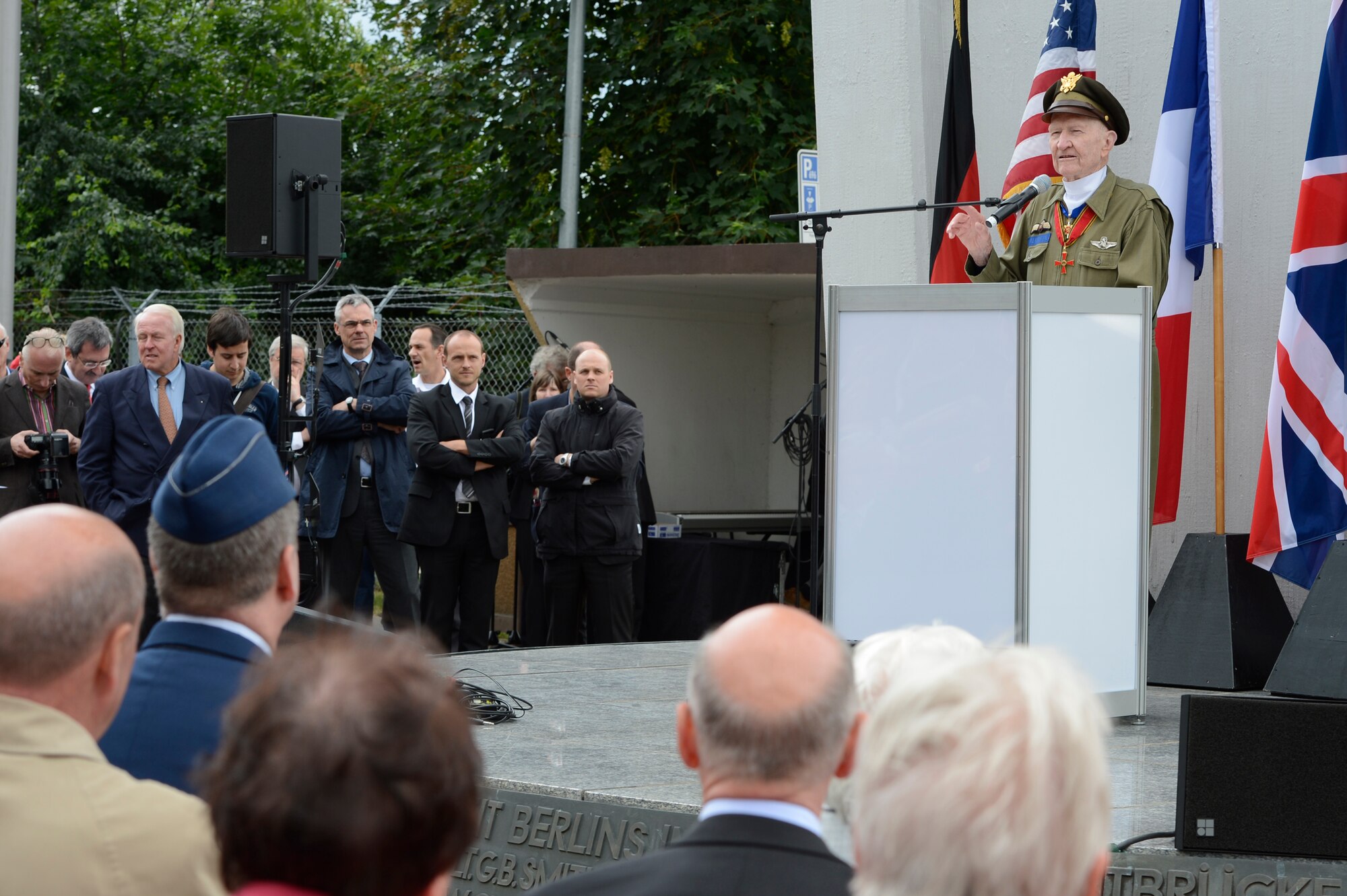 SPANGDAHLEM AIR BASE, Germany – Retired U.S. Air Force Col. Gail Halvorsen speaks to guests during the 65th of the Berlin Airlift at the Berlin Airlift Memorial in Frankfurt, Germany June 26, 2013. Halvorsen was known as the “Candy bomber” and was a guest speaker at the event. He was presented candy by local children after his speech. (U.S. Air force photo by Staff Sgt. Christopher Ruano)