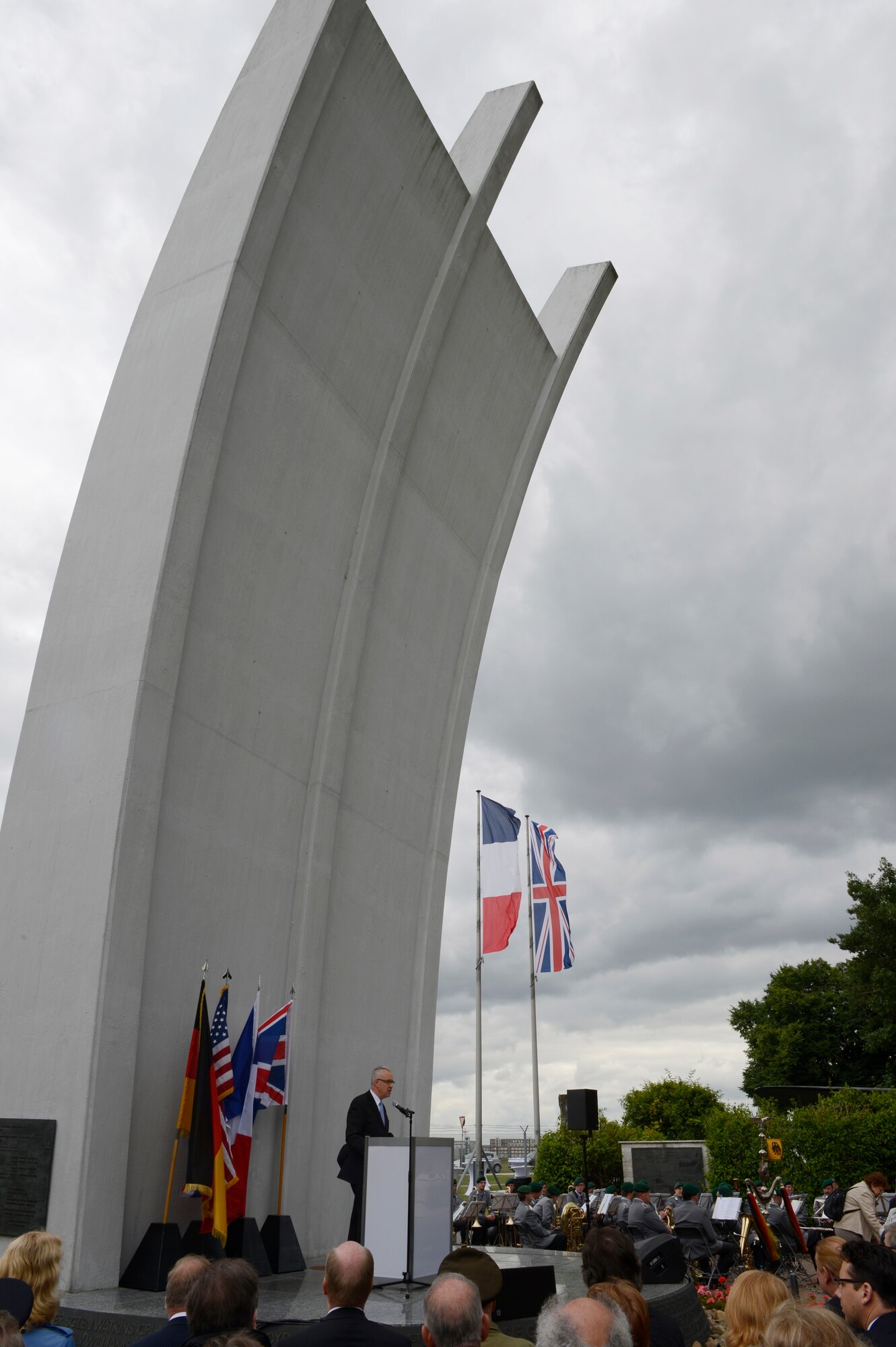 SPANGDAHLEM AIR BASE, Germany – Peter Schmitz, Frankfurt Airport director of operations, greets visitors and distinguished guests at the 65th anniversary of the Berlin Airlift. The ceremony was held at the Berlin Airlift Memorial in Frankfurt, Germany June 26, 2013. The memorial was dedicated in 1985. (U.S. Air Force photo by Staff Sgt. Christopher Ruano/Released)