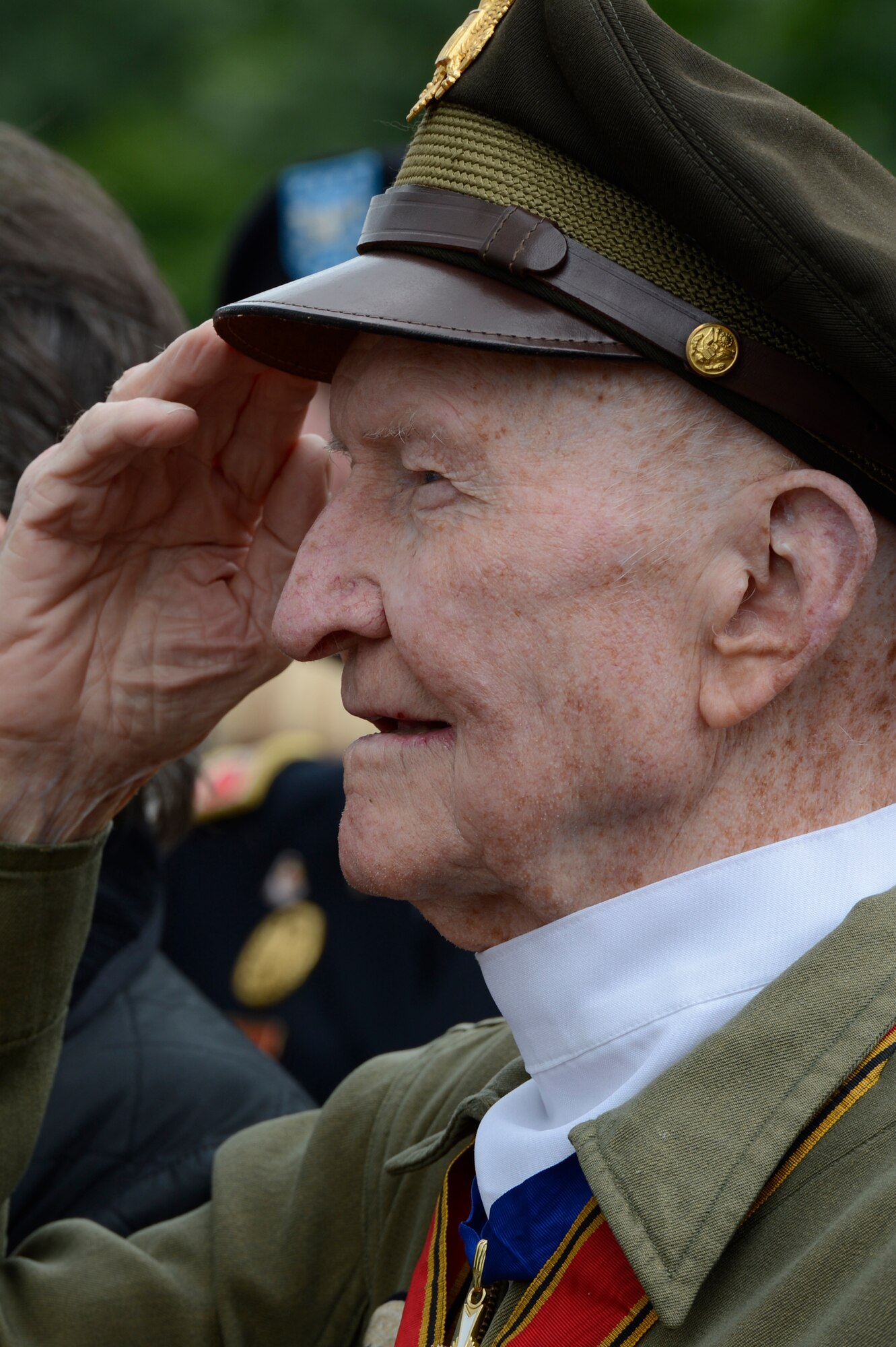 SPANGDAHLEM AIR BASE, Germany – Retired U.S. Air Force Col. Gail Halvorsen salutes during the playing of the U.S. and German national anthem during the 65th anniversary of the Berlin Airlift at the Berlin Airlift Memorial in Frankfurt, Germany June 26, 2013. Halvorsen, who dropped candy to Berlin children from 1947-1948, earned the nickname “Candy Bomber” was a guest speaker at the event. (U.S. Air Force photo by Staff Sgt. Christopher Ruano/Released)