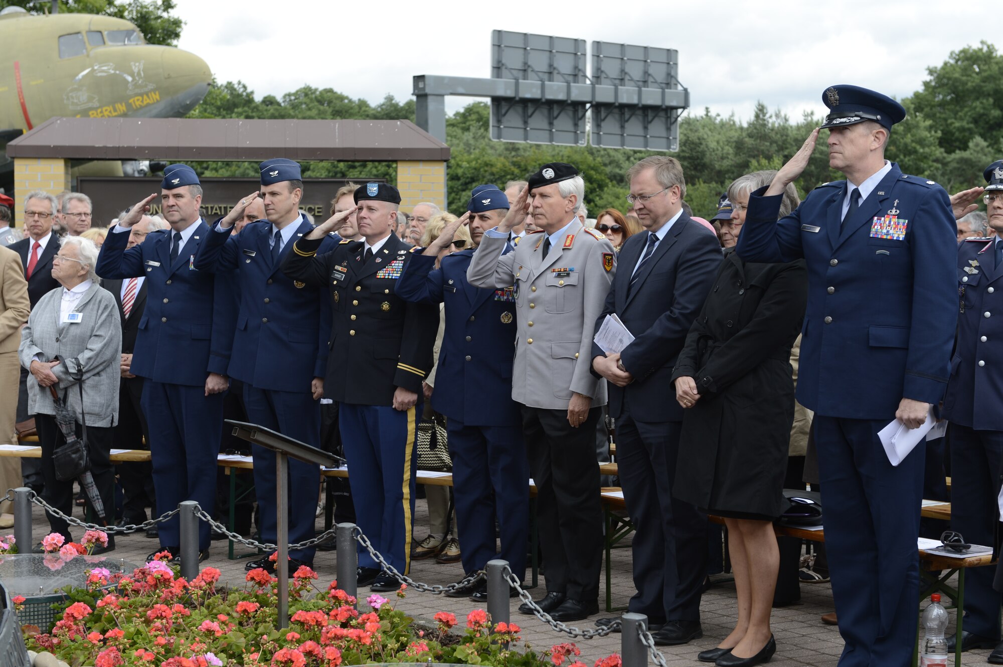 SPANGDAHLEM AIR BASE, Germany – Military service members salute during the playing of the U.S. and German national anthem during the 65th anniversary of the Berlin Airlift at the Berlin Airlift Memorial in Frankfurt Germany June 26, 2013. Service members from the U.S. Army and U.S. Air Force were present to show their respects during the ceremony. (U.S. Air Force photo by Staff Sgt. Christopher Ruano/Released)