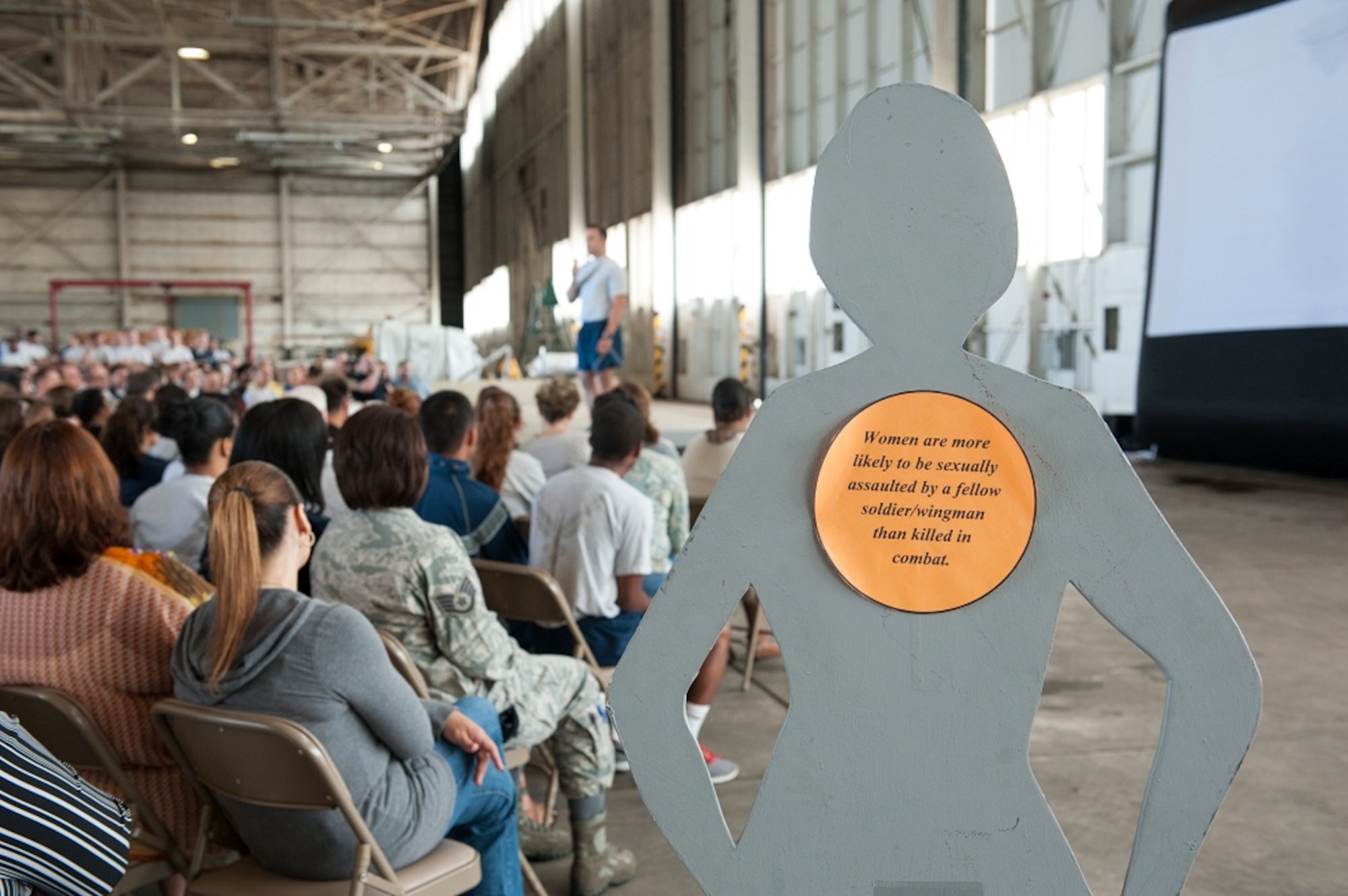 Capt. Adam Olsen, Joint Base Legal Office Military Justice chief, speaks to more than 1,000 Airmen attending the Sexual Assault Prevention and Response Stand-down Day June 19, 2013, at Big Beige, Joint Base McGuire-Dix-Lakehurst, N.J. The SAPR stand-down day was used to focus on the zero-tolerance policy of sexual assault and harassment in the military and the impact on Airmen, families and units. (U.S. Air Force photo by Russell Meseroll/Released)