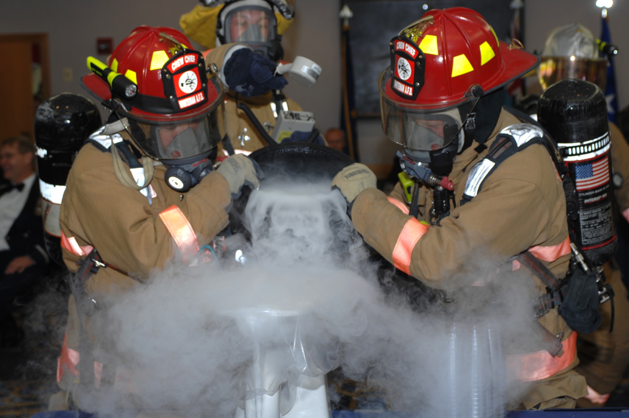 Firefighters and the hazardous material team from the 509th Civil Engineer Squadron present the “grog bowl” at the fourth B-2 Pilot Dining-In June 14, 2013, at Whiteman Air Force Base, Mo. In attendance were 133 B-2 pilots, including 51 who found their way back to Whiteman from as far away as Portugal. (U.S. Air Force photo by Staff Sgt. Brigitte N. Brantley/Released)