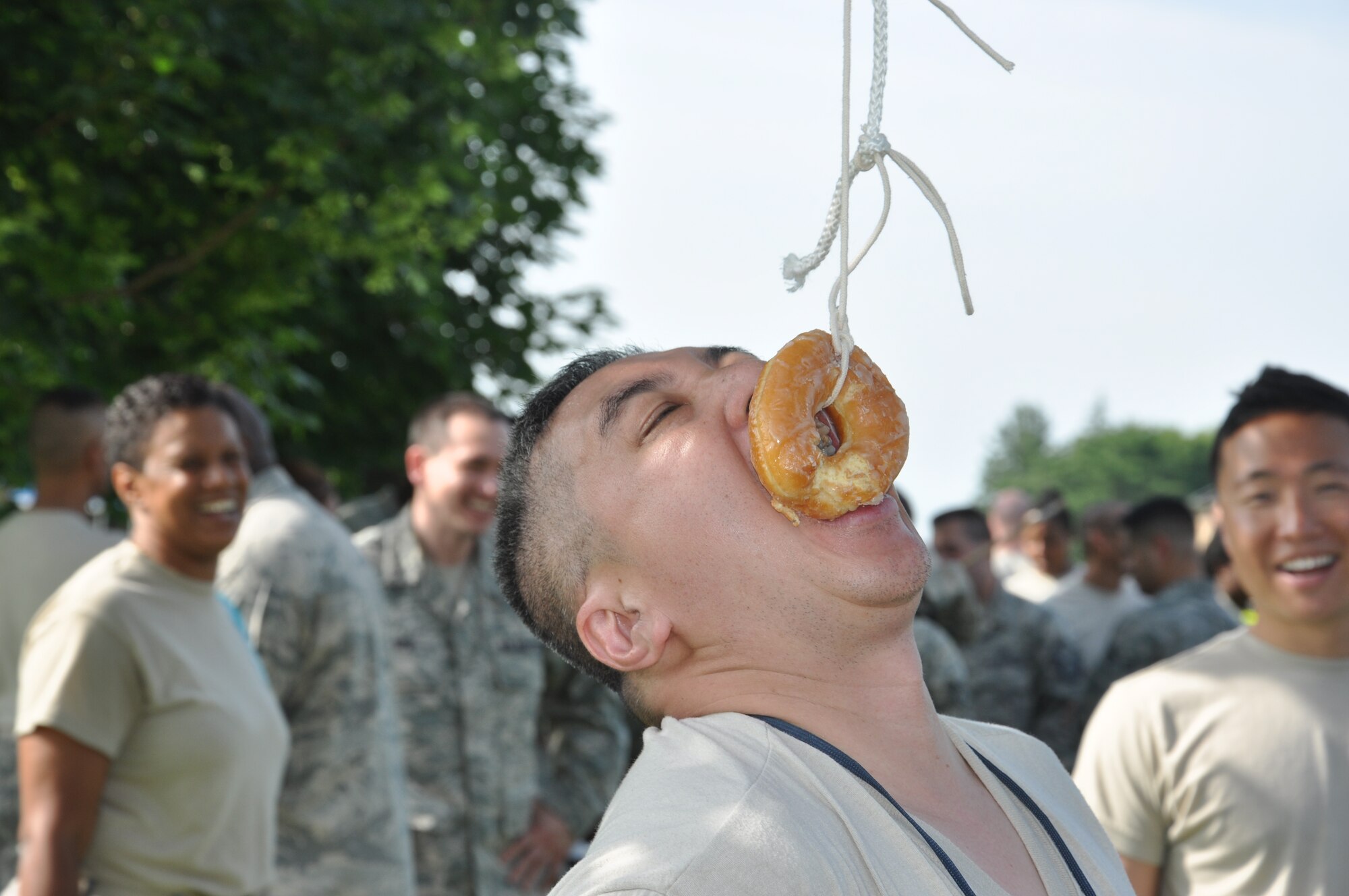 Airmen cheer as Tech. Sgt. Rey I Madlansacay attempts to eat a doughnut connected to a string during the 514th Air Mobility Wing Human Resource Development Council (HRDC) mentoring workshop held here, Jun. 22-23. (U.S. Air Force photo by Tech. Sgt. Jonathan E. White)