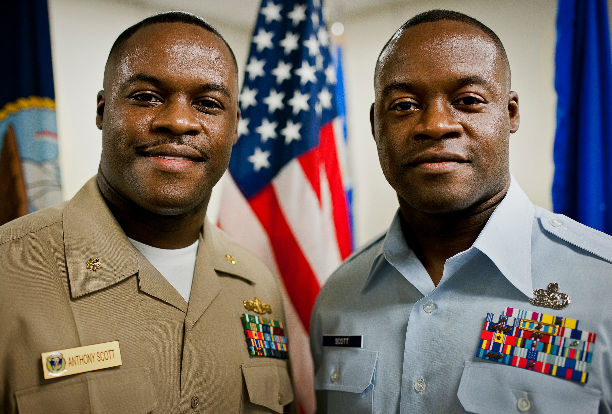 Navy Lt. Cdr. Anthony Scott stands with his twin brother Master Sgt. Antone Scott, 96th Logistics Readiness Squadron, after administering the oath of enlistment to him June 27 at Eglin Air Force Base, Fla.  Due to their schedules and service commitments, this was the first time the twins had been able to participate in the time-honored tradition.  When Anthony became a naval officer, his brother Antone was the first one to salute him.  (U.S. Air Force photo/Samuel King Jr.)