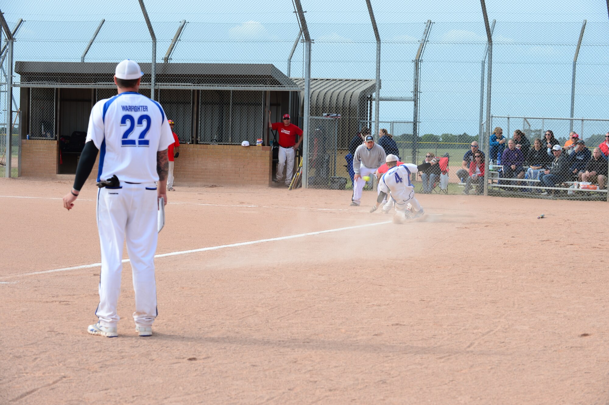 ROYAL AIR FORCE LAKENHEATH, England – Ryan Jones, Ramstein Air Base softball team member, slides into home plate to score a run during the championship game of a softball tournament here June 16, 2013.  Men and women’s softball teams from RAF Lakenheath, Ramstein Air Base, Germany, Aviano Air Base, Italy, and eight other teams from different U.S. Air Forces in Europe bases were invited to the 2nd annual softball tournament at RAF Lakenheath. (U.S. Air Force photo by Airman 1st Class Dana J. Butler)


