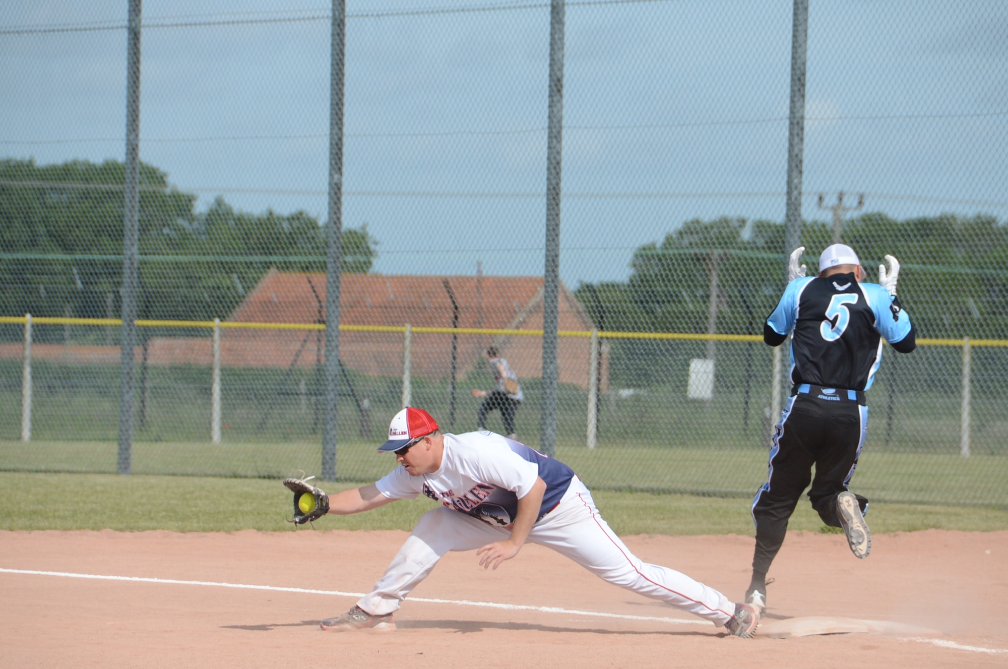 ROYAL AIR FORCE LAKENHEATH, England – An RAF Lakenheath softball team member runs through first base after hitting the ball during a softball game here June 14, 2013. Men and women’s softball teams from RAF Lakenheath, Ramstein Air Base, Germany, Aviano Air Base, Italy, and eight other teams from different U.S. Air Forces in Europe bases were invited to the 2nd annual softball tournament at RAF Lakenheath. (U.S. Air Force photo by Airman 1st Class Trevor T. McBride)