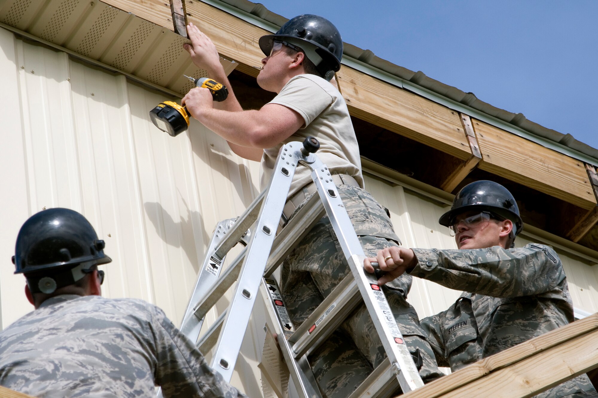 Senior Airman Dustin Fullerton, completes work on a new observation tower overlooking the M203 grenade launcher range at Grissom Air Reserve Base, Ind., as Senior Airmen Phillip Steffen and Eric Griffin assist him May 5, 2013. The Airmen are structural journeymen with the 434th Civil Engineer Squadron. (U.S Air Force photo/Staff Sgt. Andrew McLaughlin) 
