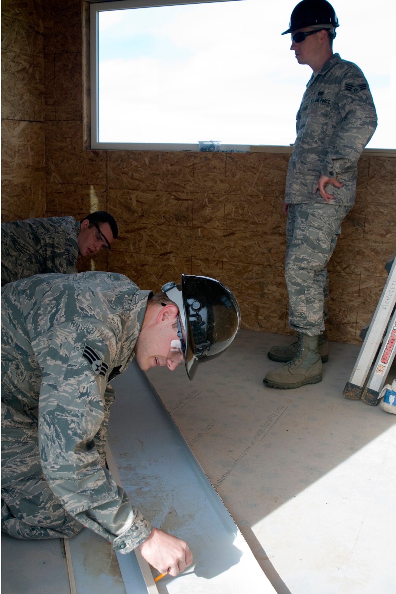 Senior Airmen Phillip Steffen, Dustin Fullerton and Eric Griffin, 434th Civil Engineer Squadron structural journeymen, complete work on a new observation tower overlooking the M203 grenade launcher range at Grissom Air Reserve Base, Ind., May 5, 2013. The tower allows 434th Security Force Squadron instructors to watch over and observe their Airmen training on the range. (U.S Air Force photo/Staff Sgt. Andrew McLaughlin) 
