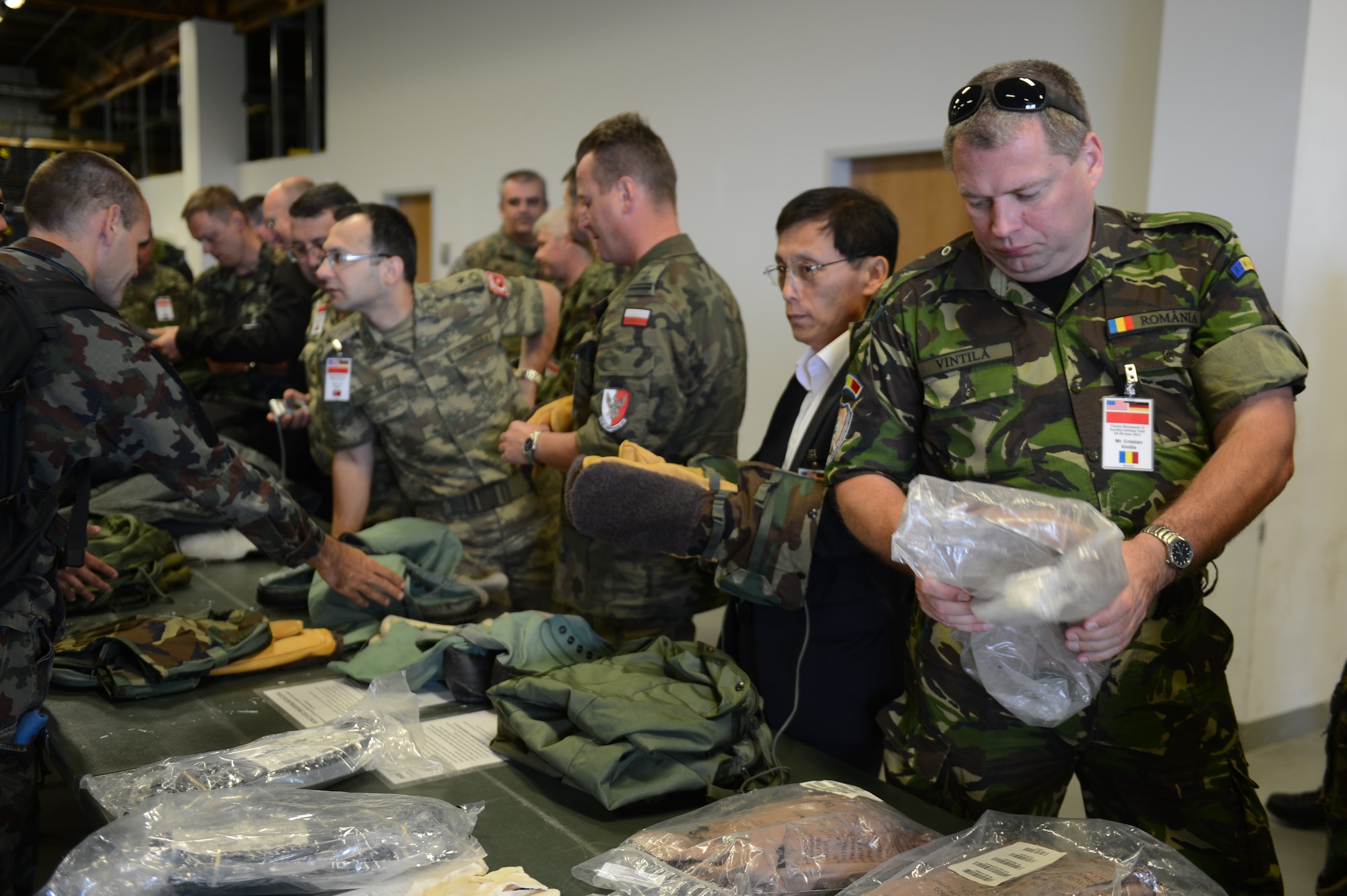 SPANGDAHLEM AIR BASE, Germany — Members of the Vienna Document 11 inspect individual protective equipment during a tour of a 52nd Logistics Readiness Squadron facility June 27, 2013. The delegates toured different areas of the base to observe the 52nd Fighter Wing's daily operations. The delegates then discuss, based on the wing's performance, whether or not the U.S. government has met the obligations of the Vienna Document 11. (U.S. Air Force photo by Airman 1st Class Gustavo Castillo/Released)