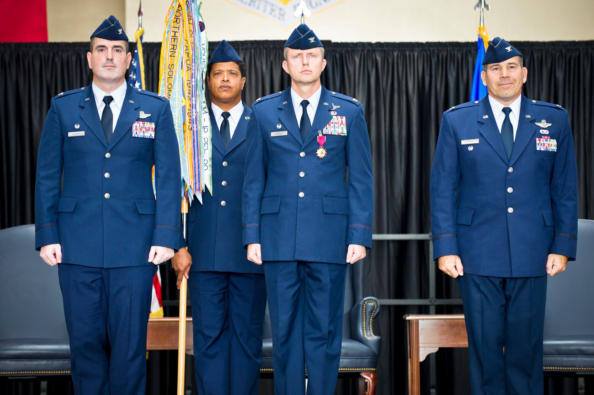 Col. Mark August, 374th Airlift Wing commander (left), stands next to Col. David Gould, 374th Operations Group outgoing commander, and Col. Robert Blagg, 374 OG incoming commander, at Yokota Air Base, Japan, June 24, 2013. (U.S. Air Force photo by Staff Sgt. Stacy Moless)