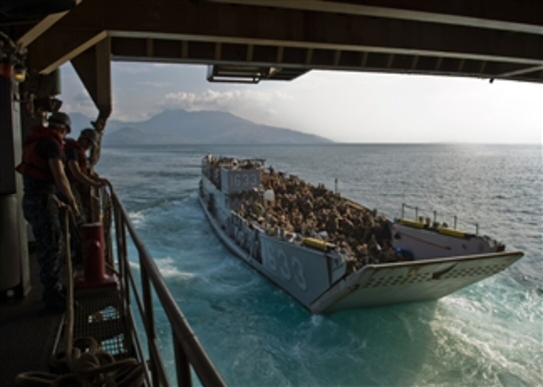 U.S. Navy Landing Craft Utility (LCU 1633) exits the well deck of the amphibious dock landing ship USS Tortuga (LSD 46) in the South China Sea on June 27, 2013.  The landing craft and its cargo of U.S. Marines are taking part in Cooperation Afloat Readiness and Training, or CARAT, exercise.  CARAT is a series of bilateral military exercises between the U.S. Navy and the armed forces of Bangladesh, Brunei, Cambodia, Indonesia, Malaysia, the Philippines, Singapore, Thailand and Timor Leste.  The Tortuga is part of the Bonhomme Richard Amphibious Ready Group.  