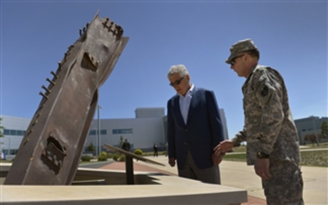 Commander, U.S. Northern Command Gen. Chuck Jacoby, right, tells
Secretary of Defense Chuck Hagel about the 9/11 monument made of a remnant of the World Trade Center outside of U.S. Northern Command headquarters at Peterson Air Force Base in Colorado Springs, Colo., on June 27, 2013.  Hagel is visiting the command to talk its senior leaders, service men and woman, and civilian employees assigned there. 