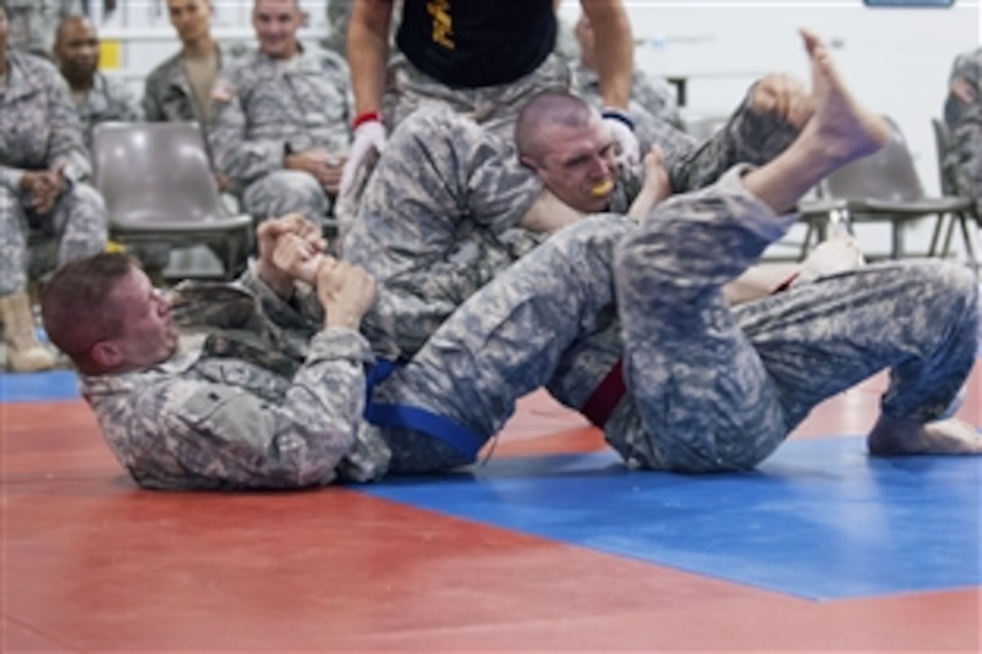 U.S. Army Reserve Cpl. Francis Kvarta uses the armbar technique on Staff Sgt. Joshua Skelton to end the match during the noncommissioned officer portion of the Modern Army Combative Tournament during the 2013 Army Reserve Best Warrior Competition on Fort McCoy, Wis., June27, 2013. Kvarta is assigned to 99th Regional Support Command, and Skelton to 75th Training Command.