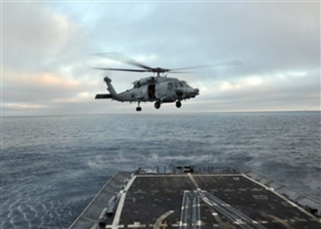 An SH-60 Sea Hawk helicopter conducts maneuvers aboard the USS Thach in the Pacific Ocean, June 25, 2013. The Thach is underway conducting joint training and operations with the U.S. Coast Guard in the U.S. 3rd Fleet area of responsibility. The Sea Hawk is assigned to Helicopter Sea Combat Squadron 21.