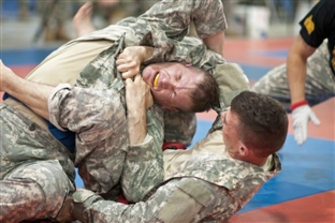 Army Reserve Cpls.  Jabriel Santos, right, and Francis Kvarta fight for a dominating position during the Modern Army Combatives tournament during the 2013 U.S. Army Reserve Best Warrior Competition on Fort McCoy, Wis., June 27. 