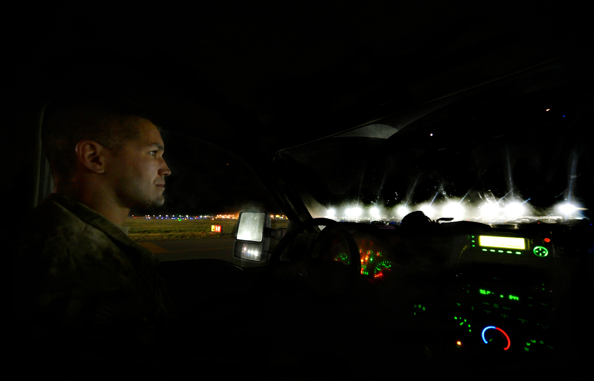 Tech. Sgt. Blake Moulden, waits to cross a taxi-way to inspect lighting on the airfield at Bagram Airfield, Afghanistan, June 6. Moulden, assigned to the 455th Expeditionary Civil Engineer Squadron electrical systems shop, is a member of a three-man airfield lighting crew in charge of maintaining more than one-thousand lights spanning over one-million square feet here. Moulden is deployed from Forbes Field, Kan., and a native of Topeka, Kan. (U.S. Air Force photo/Staff Sgt. Stephenie Wade)
