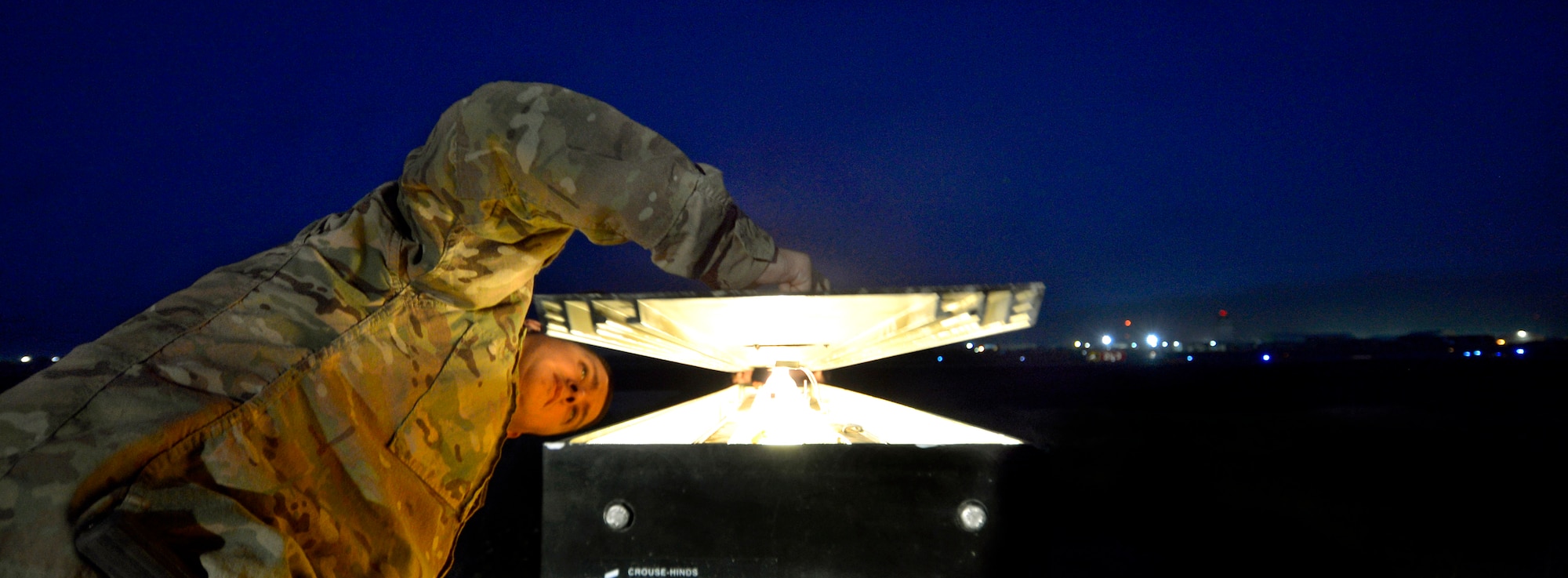 Tech. Sgt. Justin Lotero, checks a runway light to see if it’s working after replacing a bulb on Bagram Airfield, Afghanistan, June 6.  In the last six months, the three-man airfield lighting crew managed to replace 20,000 feet of conductor wire and seven out of eight stadium lights that were not working here.  Lotero is assigned to the 455th Expeditionary Civil Engineer Squadron electrical systems shop and is deployed from117 Air Refueling Wing, Birmingham, Ala. (U.S. Air Force photo/Staff Sgt. Stephenie Wade)
