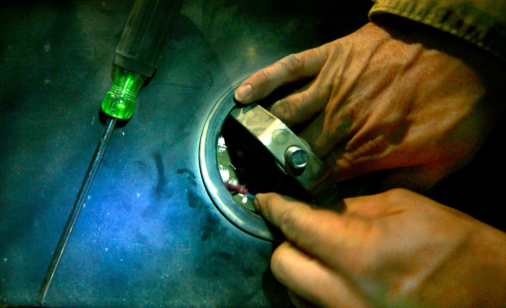 Staff Sgt. Paul Izyk replaces a bulb in a runway ramp sign on Bagram Airfield, Afghanistan, June 6. Izyk, assigned to the 455th Expeditionary Civil Engineer Squadron electrical systems shop, is a member of a three-man airfield lighting team working every night to maintain all the lights on the Department of Defense’s single busiest runway, transiting more than two-thousand aircraft movements per a month.  Izyk is deployed from the 136 Airlift Wing, Fort Worth, Texas and a native of Oswego, N.Y. (U.S. Air Force photo/Stephenie Wade)