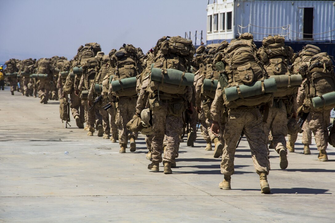 U.S. Marines and U.S. Sailors assigned to the 26th Marine Expeditionary Unit (MEU), prepare to load a landing craft utility during the offload of Exercise Eager Lion 2013, Gulf of Aqaba, Jordan, June 21, 2013. Exercise Eager Lion 2013 is an annual, multinational exercise designed to strengthen military-to-military relationships and enhance security and stability in the region by responding to modern-day security scenarios. The 26th MEU is a Marine Air-Ground Task Force forward deployed to the U.S. 5th Fleet area of responsibility aboard the Kearsarge Amphibious Ready Group serving as a sea-based, expeditionary crisis response force capable of conducting amphibious operations across the full range of military operations. (U.S. Marine Corps photo by Lance Cpl. Juanenrique Owings, 26th MEU Combat Camera/Released)