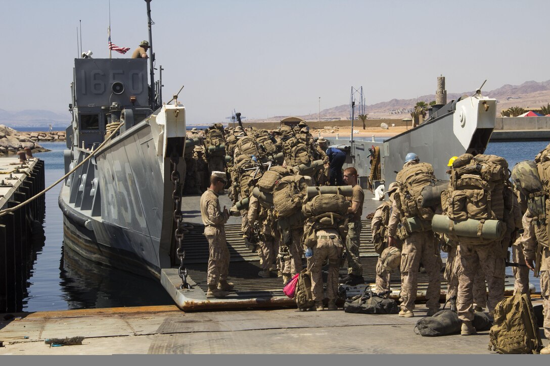 U.S. Marines and U.S. Sailors assigned to the 26th Marine Expeditionary Unit (MEU), load a landing craft utility during the offload of Exercise Eager Lion 2013, Gulf of Aqaba, Jordan, June 21, 2013. Exercise Eager Lion 2013 is an annual, multinational exercise designed to strengthen military-to-military relationships and enhance security and stability in the region by responding to modern-day security scenarios. The 26th MEU is a Marine Air-Ground Task Force forward deployed to the U.S. 5th Fleet area of responsibility aboard the Kearsarge Amphibious Ready Group serving as a sea-based, expeditionary crisis response force capable of conducting amphibious operations across the full range of military operations. (U.S. Marine Corps photo by Lance Cpl. Juanenrique Owings, 26th MEU Combat Camera/Released)