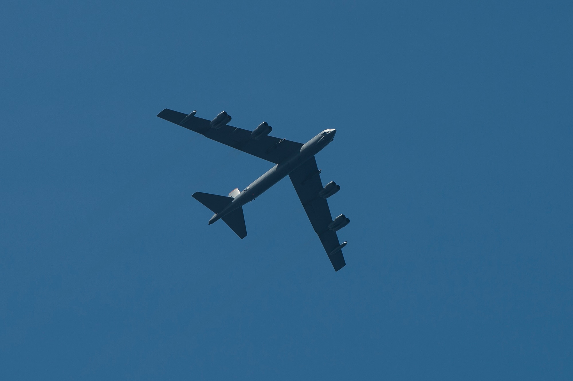 A B-52 Stratofortress flies over USS Preble (DDG 88), an Arleigh Burke-class guided-missile destroyer, June 24, 2013, following an electronic warfare exercise during Pacific Bond 2013. Pacific Bond 2013 was a U.S. Navy, Royal Australian Navy and Japan Maritime Self Defense Force maritime exercise designed to improve interoperability and further relations between nations. (U.S. Navy photo by Mass Communication Specialist 3rd Class Paul Kelly/Released)