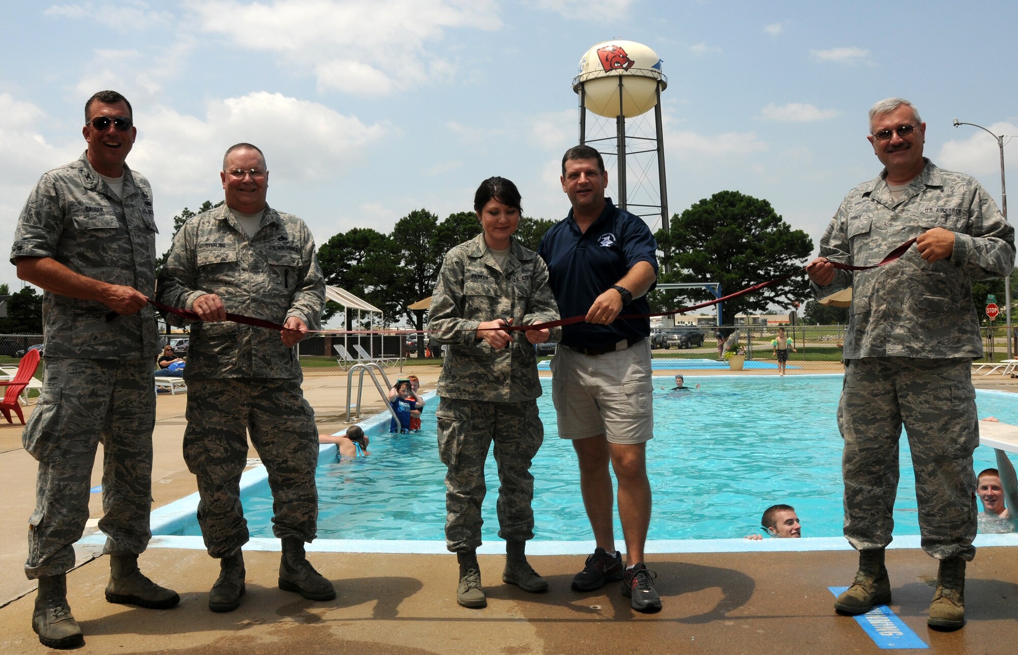 From left to right: Col. Pete Gauger, 188th Fighter Wing vice commander; Chief Master Sgt. Larry  Sterling; Tech Sgt. Rachael Parker; Master Sgt. Mark Allen, base pool committee president; and Senior Master Sgt. Vince Prince conduct a ribbon cutting ceremony at the wing’s base pool June 20. The 188th Fighter Wing’s base swimming pool has been around more than most of its members have been alive. One of the first original construction projects at Ebbing Air National Base in Fort Smith, Ark., the 188th’s base pool had fallen on hard times recently and required more than $25,000 in repairs and upgrades in order to meet the necessary requirements to reopen. Thanks to Master Sgt. Mark Allen, 188th base pool committee president, along with several dedicated, hard-working volunteers, the 188th’s pool is now up and running. The 188th held an official ribbon cutting June 20 to officially open the pool. The ribbon-cutting was followed by a wing luncheon, which fostered camaraderie throughout the unit. (U.S. Air National Guard photo by Senior Airman John Hillier/188th Fighter Wing Public Affairs)