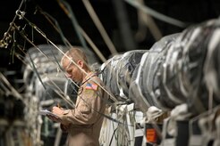 Staff Sgt. Tim Jaskot, 816th Expeditionary Airlift Squadron loadmaster, inspects weight and balance for an airdrop at Kandahar Airfield, Afghanistan, June 27, 2013. The C-17A Globemaster III crew performed two airdrops in the remote regions of Kandahar province. Jaskot hails from Wintergarden, Fla., and is deployed from Joint Base Charleston, S.C. (U.S. Air Force Photo/Master Sgt. Ben Bloker)