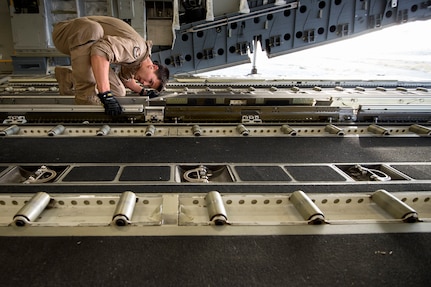 Staff Sgt. Dennis Conner, 816th Expeditionary Airlift Squadron loadmaster, configures a C-17A Globemaster III for an airdrop out of Kandahar Airfield, Afghanistan, June 27, 2013. The Globemaster crew performed two airdrops in remote regions of Kandahar province. Conner hails from Charlotte, N.C., and is deployed from Joint Base Charleston, S.C. (U.S. Air Force Photo/Master Sgt. Ben Bloker)