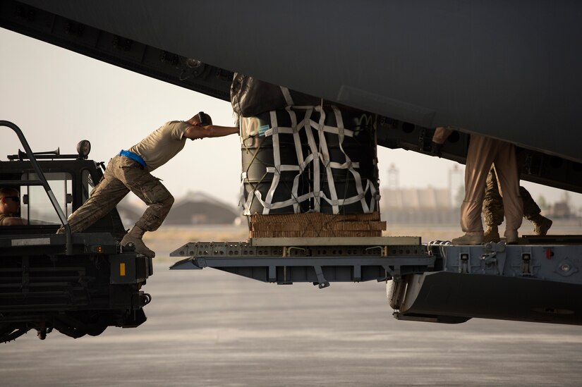 An airman from the 451st Expeditionary Logistics Readiness Squadron aerial port flight transfers pallets to a C-17A Globemaster III for an airdrop out of Kandahar Airfield, Afghanistan, June 27, 2013. The Globemaster crew performed two airdrops in remote regions of Kandahar province. (U.S. Air Force Photo/Master Sgt. Ben Bloker)