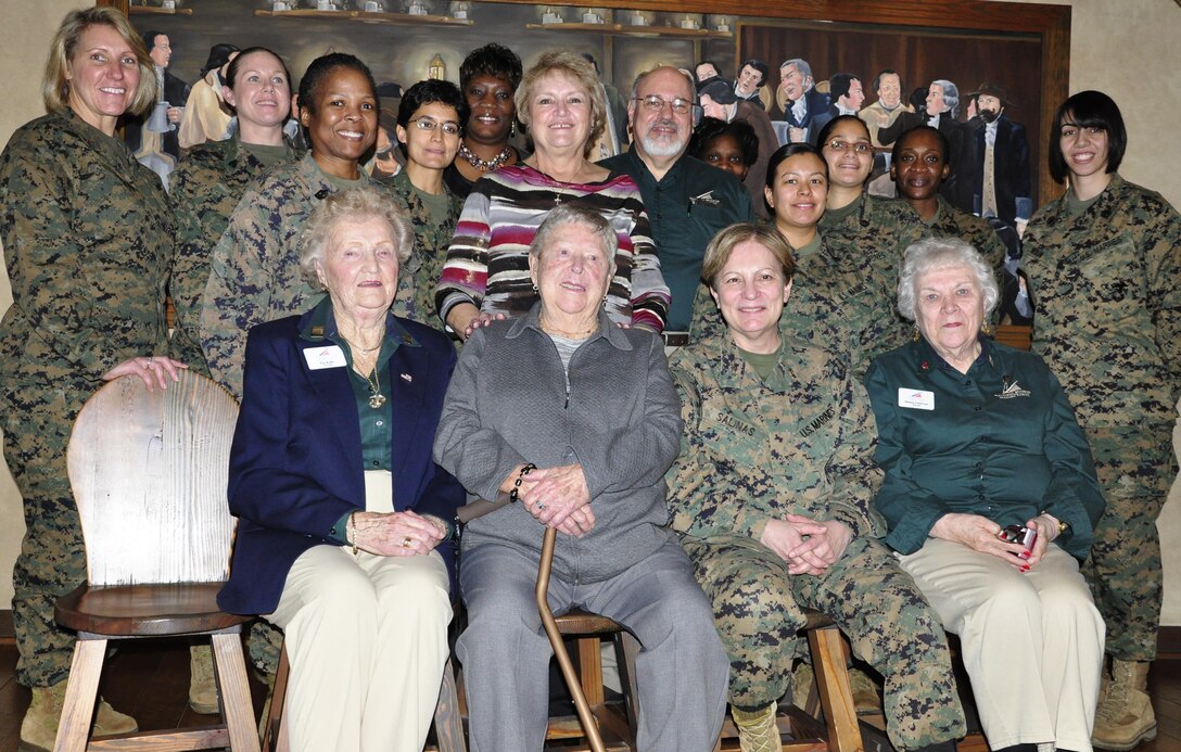 Women Marines from World War II to present gather together for a group picture after eating lunch together and sharing their Marine Corps experiences with each other at the National Museum of the Marine Corps on Feb. 27. Feb. 13 was the anniversary of the establishment of the Marine Corps Women Reserve and Marge Alexander’s, front row, second from the left, 90th birthday. 