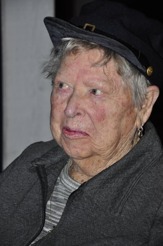 Marjorie “Marge” Alexander, World War II veteran, tries on the hat from one of the recreated, historical uniforms on display at the National Museum of the Marine Corps during a tour of the museum Feb. 27. Alexander, a Marine, served from 1943-45 as a motor transport operator. 