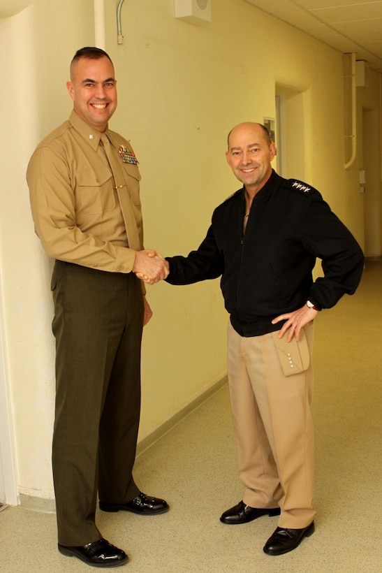 Admiral James G. Stavridis, the supreme allied commander for Europe and commander of U.S. European Command shakes hands with Lt. Col. Rick Coates, future/current operations officer for Marine Forces, Europe during his tour of the Marine Corps Forces, Europe and Africa headquarters building. Stavridis walked the halls of the headquarters, stopping to talk to Marines and civilians. This was his last stop before returning to NATO headquarters in Belgium. 