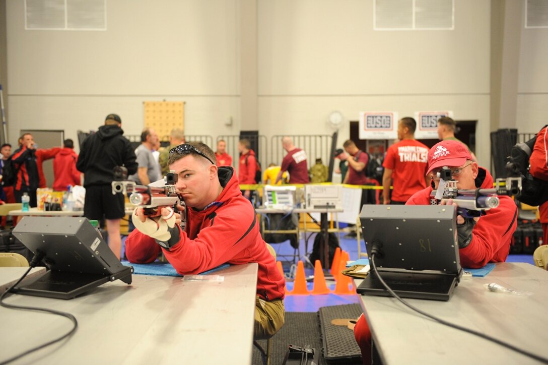 United States Marine Corps Staff Sergeant Benjamin Harrelson (left) and Captain Joseph Elder (right) sight in on their targets with their air rifles at the 2013 Marine Corps Trials in Camp Pendleton, Ca., Feb. 27, 2013. Staff Sergeant Harrelson and Captain Elder compete for the first time in the Marine Corps Trials for a spot on the All-Marine Warrior Games Team.