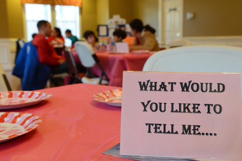Parents ask questions that were placed on their table to their children during the Families OverComing Under Stress program event, “Having Dinner with the Family” at the Lincoln Military Housing Family Center on Feb. 28. FOCUS collaborated with Lincoln Military Housing to hold this event. 